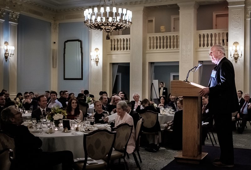 Professor Michael Brennan speaking from a podium